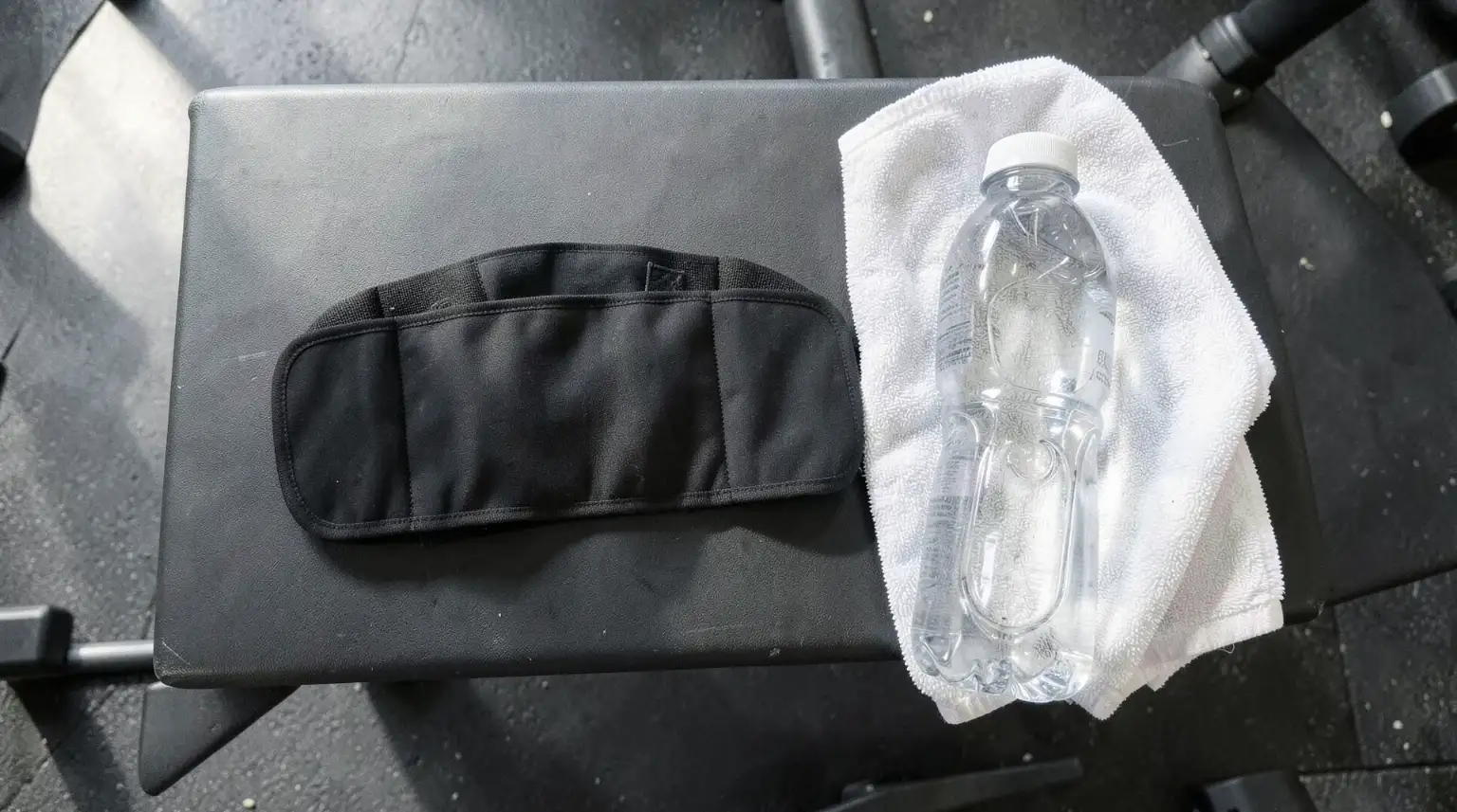 Waist trimmer and gym accessories on bench